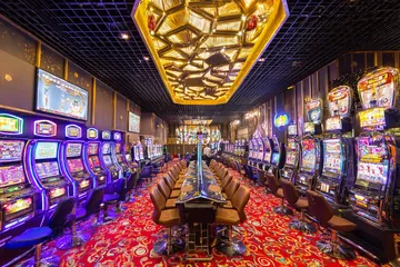 A close-up shot of golden coins falling around a spinning roulette wheel, representing immersive casino action at RK888.